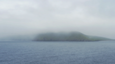 beautiful-landscape-of-a-mysterious-island-wrapped-in-fog-mist-in-the-middle-of-the-oceac-4k-video_shrslkldl_thumbnail-1080_01.png