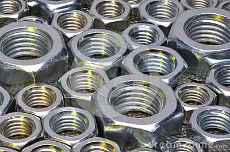 shiny-nuts-metal-surface-abstract-industry-background-49212263.jpg